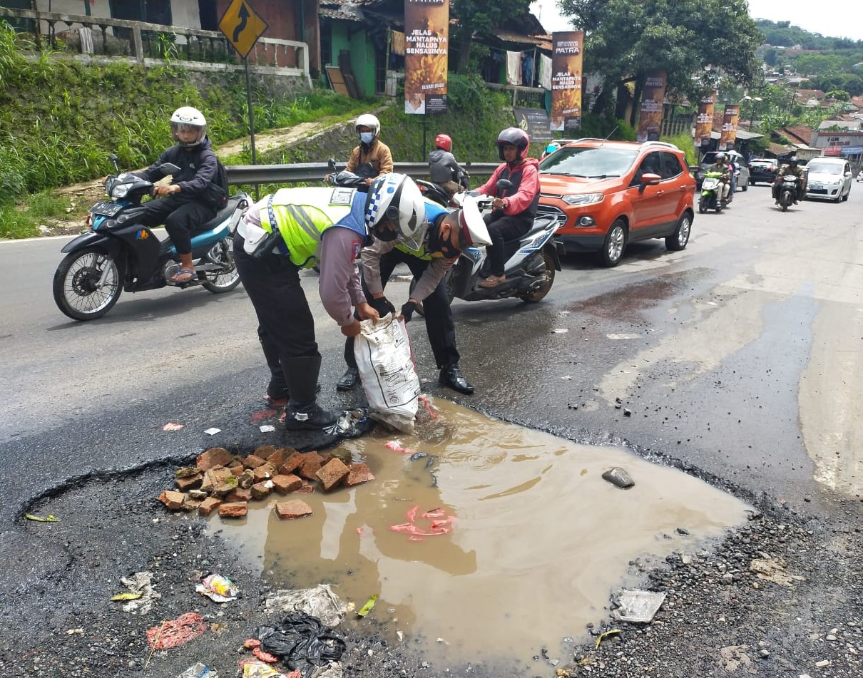 jalan nasional berlubang diperbaiki polisi