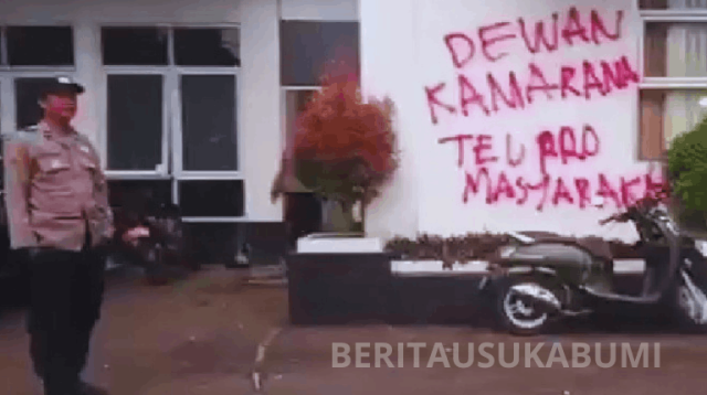 Peserta Aksi 2.6.26 Sukabumi Melawan mencoret dinding Gedung DPRD Kota Sukabumi sebagai bentuk kekecewaan. Massa mendesak DPRD membentuk hak angket terhadap Wali Kota Ayep Zaki.